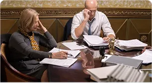 A legal team reviewing case files at a desk