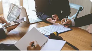Colleagues reviewing an employment agreement at a desk