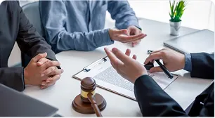 A solicitor advising a client across a desk